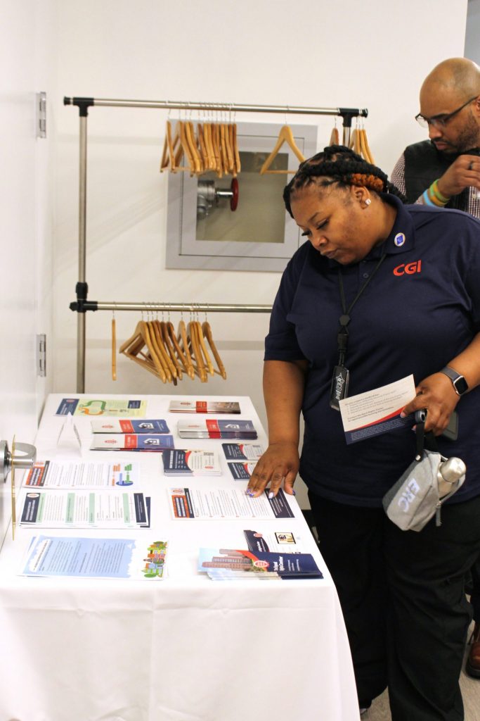 A guest at the ERC's 2025 Annual Meeting peruses fair housing resources.