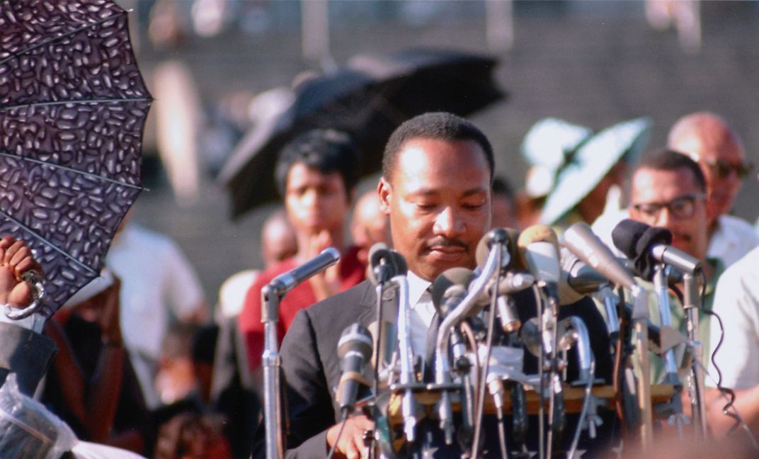 Dr. King stands at a podium